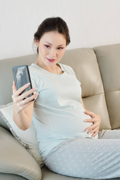 istock Pregnant woman taking selfie 1217150908