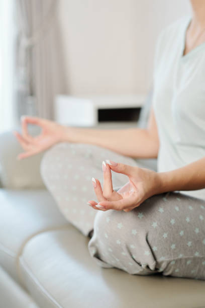 istock Woman meditating at home 1217150929