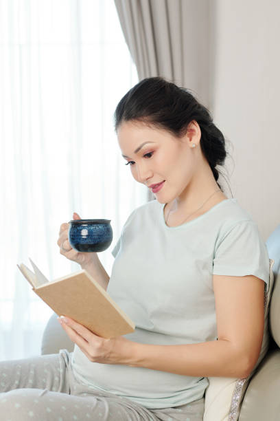istock Pregnant woman reading book 1217150940