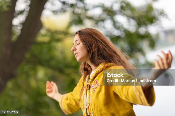 A Woman Meditating In Nature Stock Photo - Download Image Now - Chanting, New Age, Religion