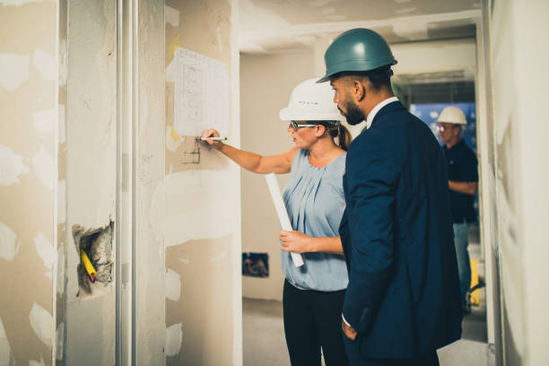 istock Architect discussing blueprint with investor 1217153124