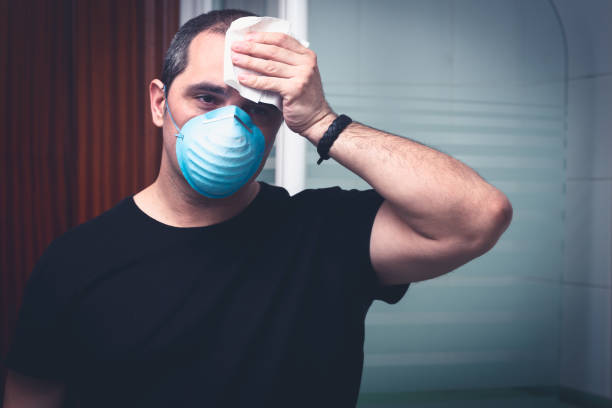 istock sick man wiping sweat with a handkerchief 1217153345