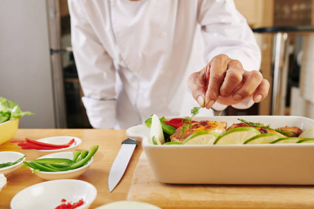 istock Chef garnishing baked chicken 1217153454