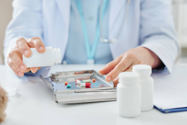 istock Doctor emptying container of medicine 1217155320