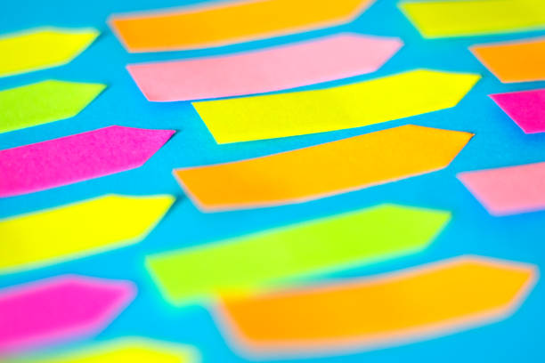 istock Colorful Empty Arrow-shaped sticky papers are on blue paper 1217157109