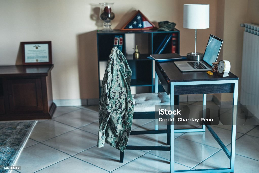 Learning doesn't stop even when you're in the military Shot of a laptop on a desk in a soldier’s bedroom Veteran Stock Photo