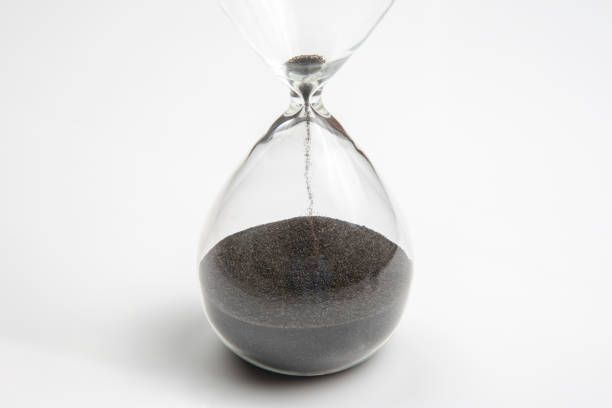 istock Hourglass on a light background. Time is money. Business solutions in time. 1217159995