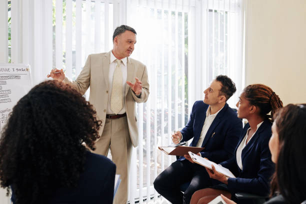 istock Entrerpreneur talking to colleagues 1217160417