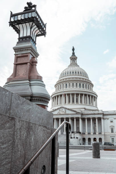 US Capitol Building in Washington DC A decorative lamp next to the stairs with the US Capitol Building in the background. united states senate committee on health education labor and pensions stock pictures, royalty-free photos & images