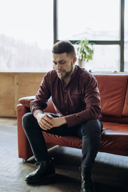 istock A young man sits on the couch and talks about something 1217163423