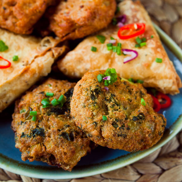 istock Indian Vegetable snacks -  pakora, samosa, onion bhaji with coriander and chili. 1217163735