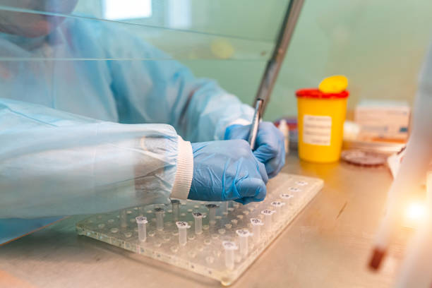 istock Serious clinician studying chemical element in laboratory. 1217163780