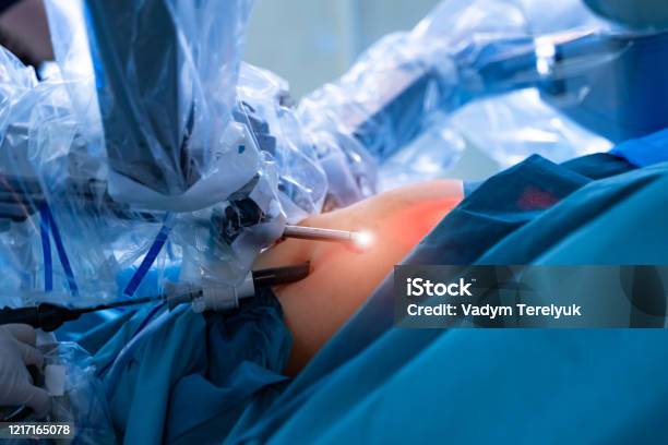 Surgical Room In Hospital With Robotic Technology Equipment Machine Arm Surgeon In Futuristic Operation Room Stock Photo - Download Image Now