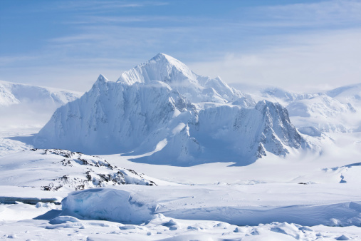 mountain peak is covered with white snow in Antarctica