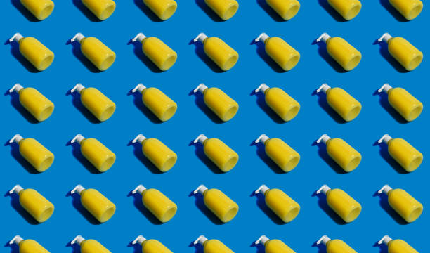 Liquid antibacterial dispenser soap seamless pattern. Yellow banana pump soap for washing hands pattern on blue background. Stay safe- wash hands.