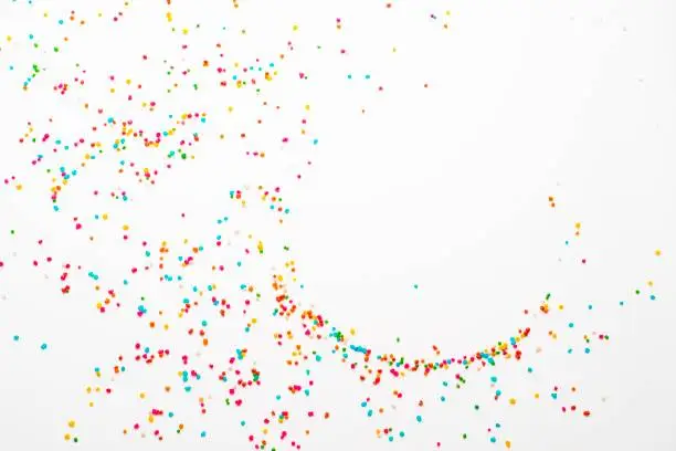 Image made in studio  over white background of sugar sprinkles