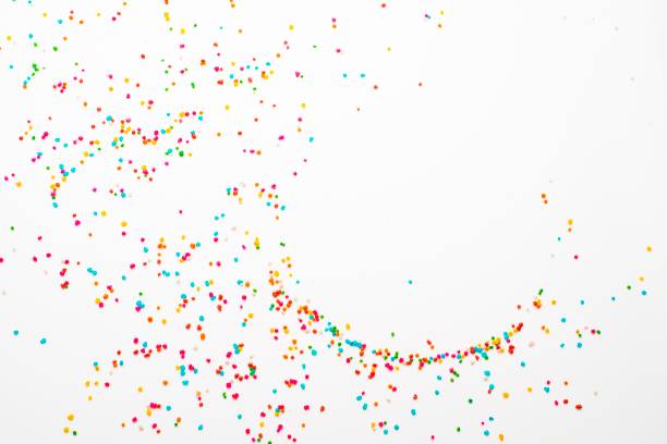 sugar sprinkles on white table - confeito colorido para bolos imagens e fotografias de stock