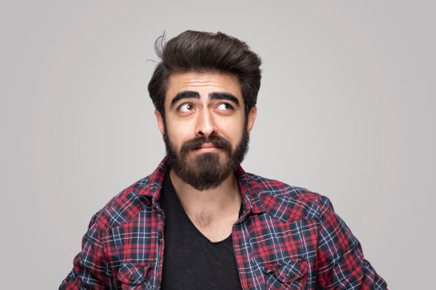 istock Portrait of thoughtful young  men over isolated grey background 1217169320