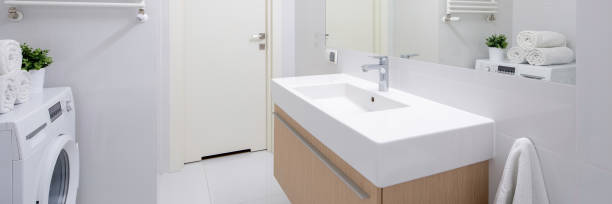 istock Simple bathroom with long washbasin, panorama 1217170493