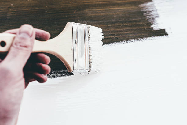 istock close-up of hand using brush to paint wood 1217171256