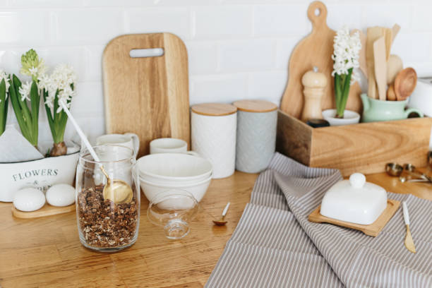 istock Kitchen utensils and dishware spring flowers on wooden table. 1217171755