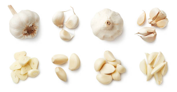 Set of fresh whole and sliced garlics Set of fresh whole and sliced garlics isolated on white background. Top view garlic clove photos stock pictures, royalty-free photos & images
