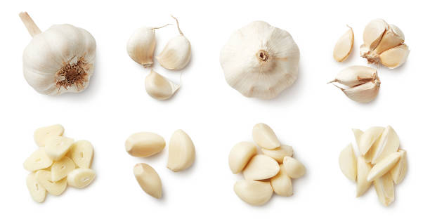 Set of fresh whole and sliced garlics Set of fresh whole and sliced garlics isolated on white background. Top view garlic clove stock pictures, royalty-free photos & images