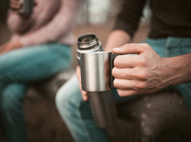 istock Males Hand With Cup And Thermos, Camping Break 1217172508