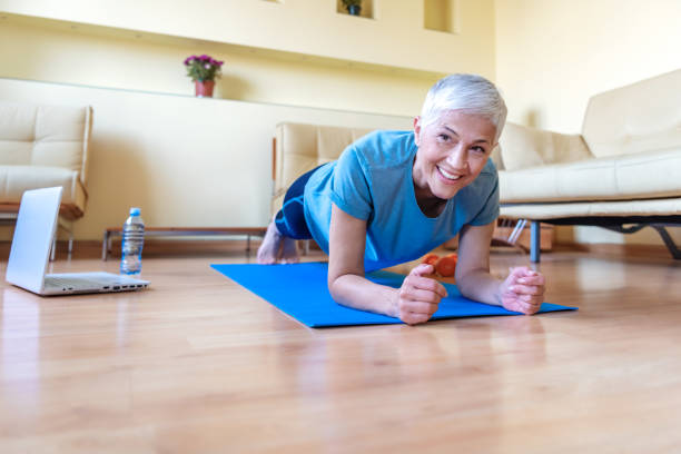 istock Senior woman exercising in home gym- Quarantine 1217173699