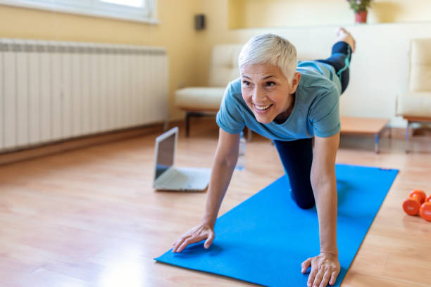 istock Mature Woman Exercise At Home - Quarantine 1217174240