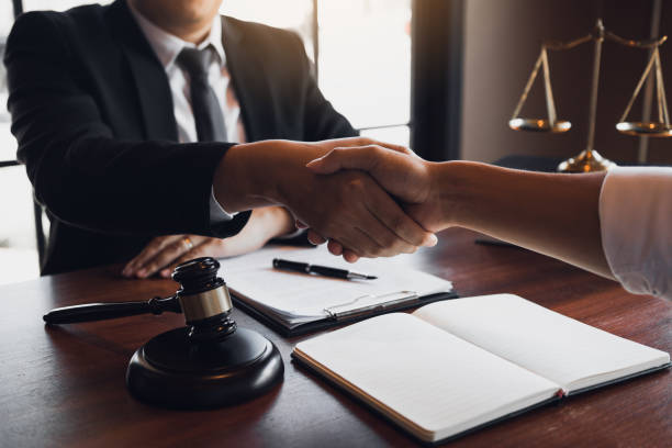 istock Lawyer is currently shaking hands with the client about the success in resolving the case. 1217175175
