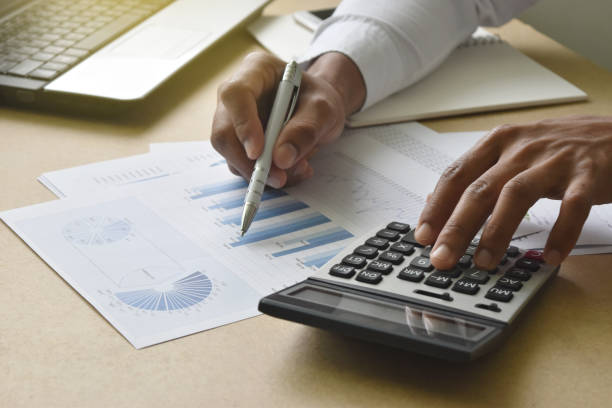 istock businessman working analyzing financial graphs and charts report on desk in office. 1217175746