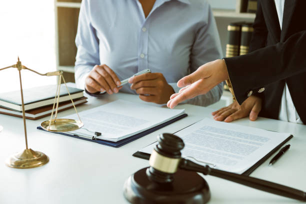 istock Lawyer is explaining about the wrongdoing laws regarding fraud to the client at the office. 1217175895