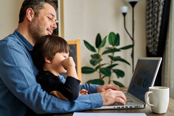 istock Businessman working at home with child. 1217176689
