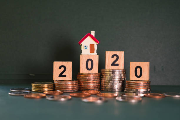 istock Mini house on wooden block year 2020 1217176704
