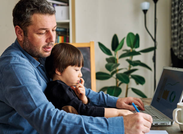 istock Businessman working at home with child. 1217177111