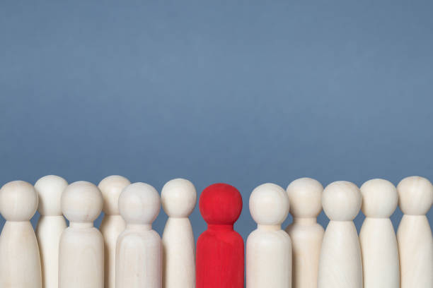 istock A row of human figures with one individual being different through diversity or infected by Coronavirus 1217177511