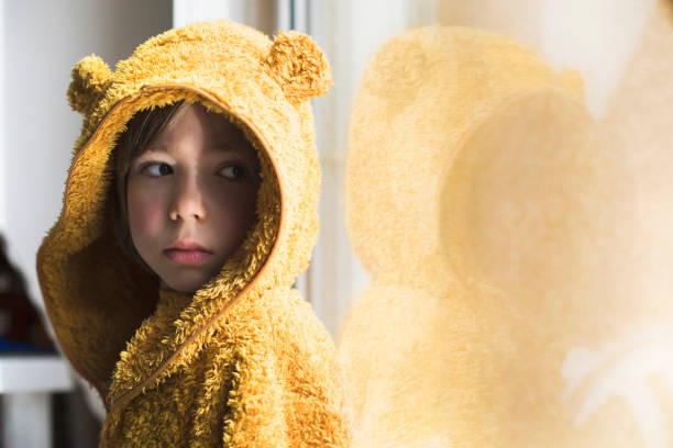 Sad child in isolation at home for virus outbreak. Sadness. Depression. Loneliness.