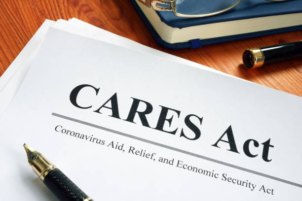 Coronavirus Aid, Relief, and Economic Security CARES Act on the desk. Coronavirus Aid, Relief, and Economic Security CARES Act on the desk. bill legislation stock pictures, royalty-free photos & images