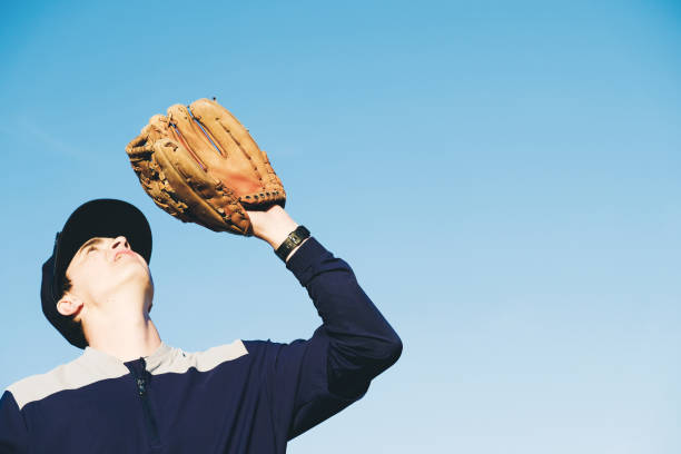istock Baseball player with glove up for catch, copy space on background 1217184228