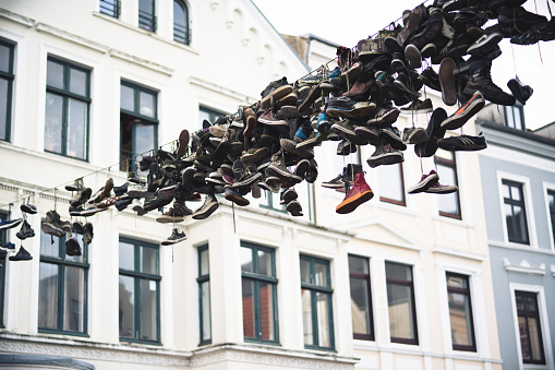 Old boots hanging on rope in Flensburg.\n47 Megapixels, Shot in January 2018 with