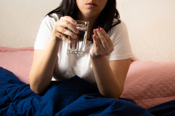 istock sick woman in bed with a cold 1217185480