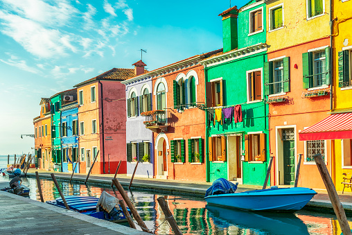 View of the colorful houses along the canal at the island of Burano near Venice, Italy.