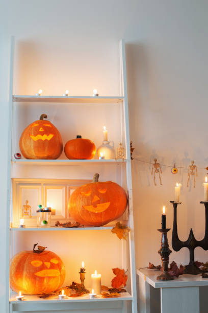 istock halloween pumpkins with candles on wooden table 1217186384