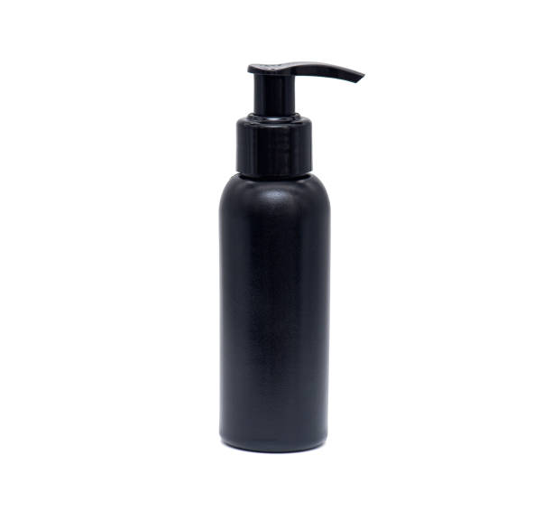 istock Black plastic bottle, container for foam or cream isolated on white background 1217186614