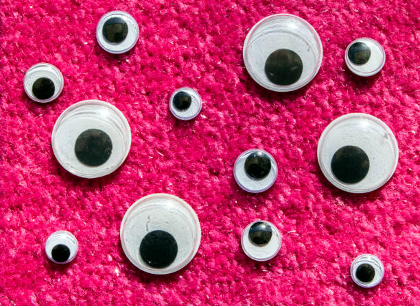 istock Funny Wiggle Google Eyes on Fabric Silly Background 1217186638