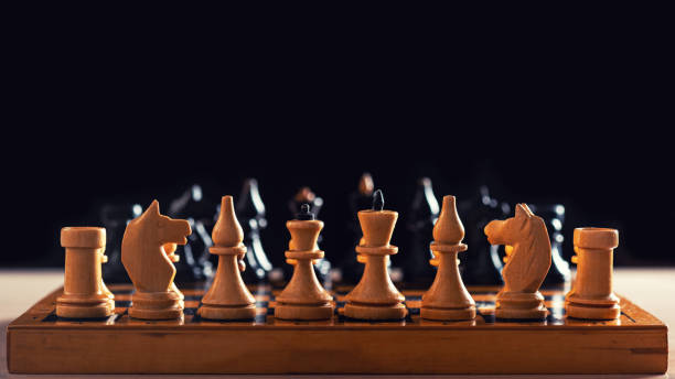 istock Vintage handmade wooden chess board and figures 1217189730