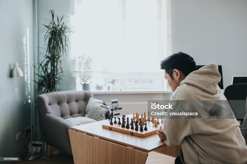 Japanese Man Playing Virtual Chess With Friend Online During