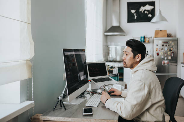 istock Japanese day trader working at home 1217191712