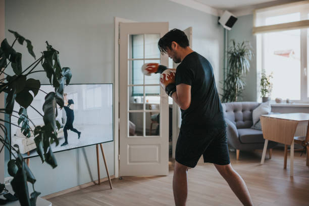 Japanese man taking online boxing lessons during lockdown in isolation